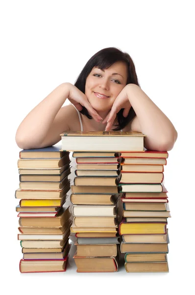 Giovane donna sorridente con mucchio di libri — Foto Stock