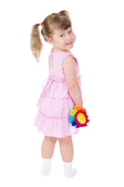 Liten leende flicka med leksak blomma — Stockfoto