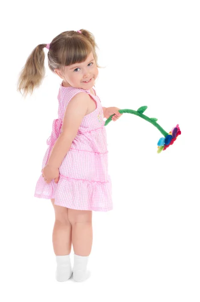 Little smiling girl with toy flower — Stock Photo, Image