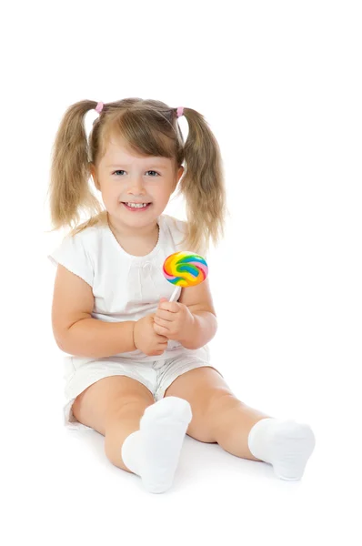 Маленька усміхнена дівчинка з льодяником — стокове фото