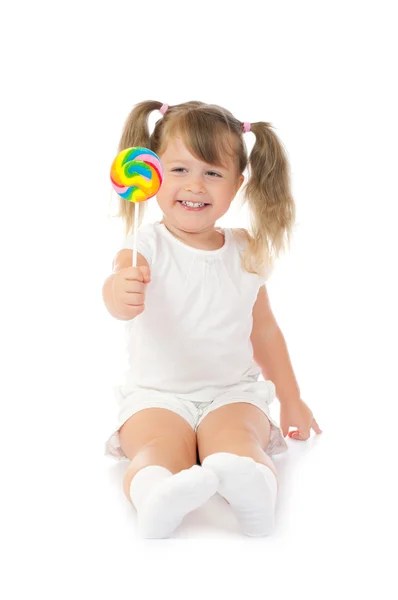 Malá usměvavá dívka s lízátkem — Stock fotografie