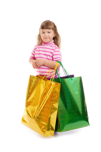 Klein lachend meisje met tassen — Stockfoto