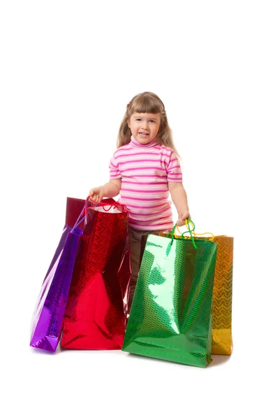 Little smiling girl with bags — Stock Photo, Image
