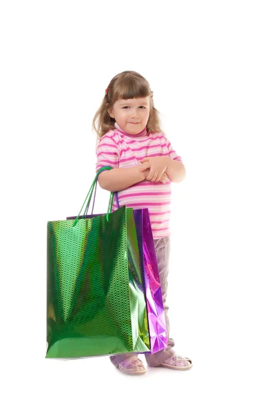 Mała uśmiechnięta dziewczynka z torbami — Zdjęcie stockowe