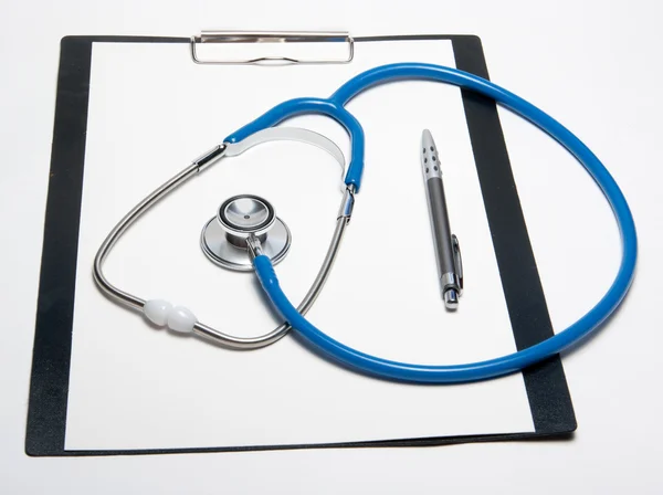Stethoscope and pen on paper sheet — Stock Photo, Image