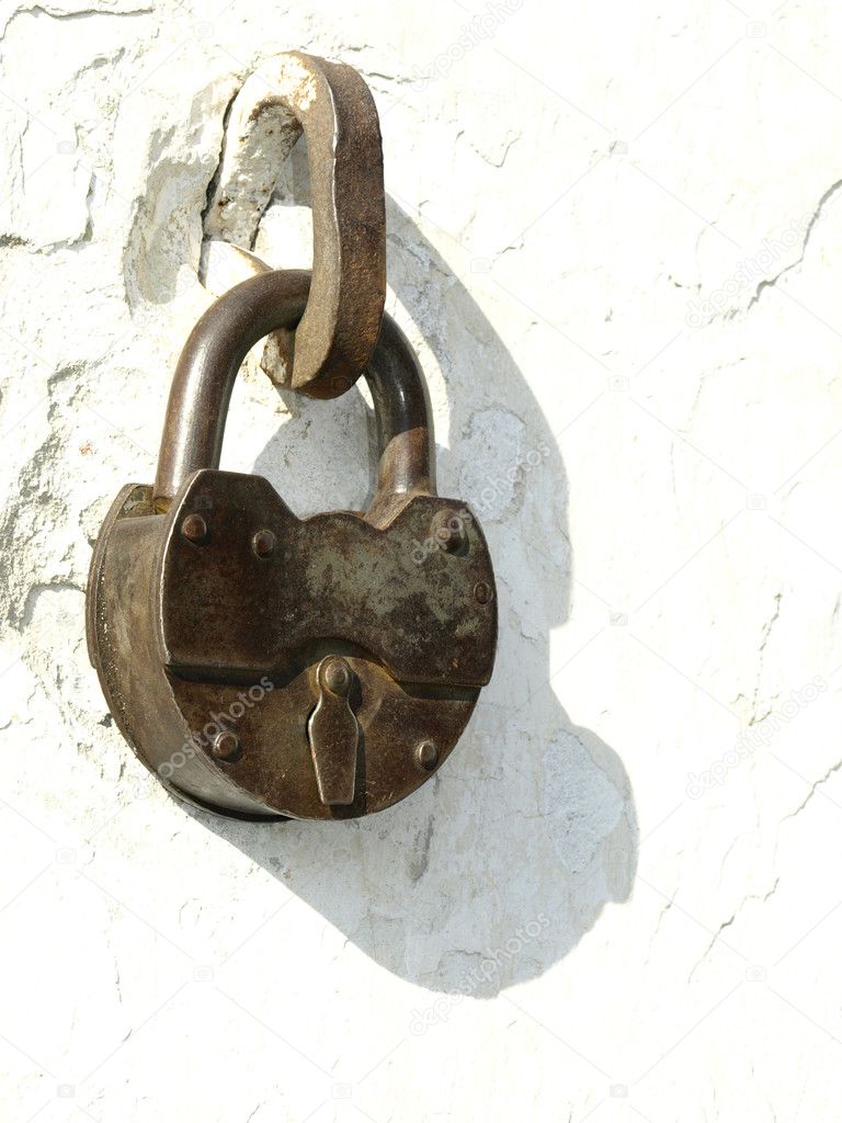 old locks on a white background of an old wall stock photo
