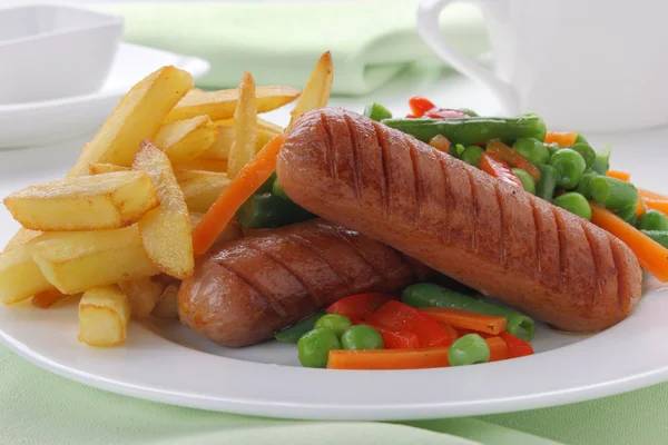 Sausage with french fries and vegetables — Stock Photo, Image