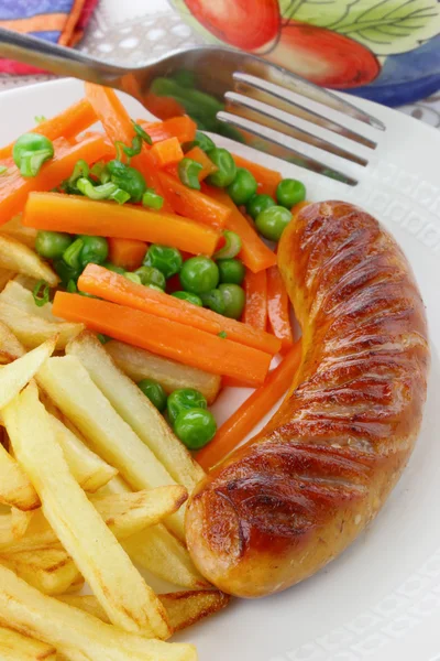 Sausage with french fries and vegetables — Stock Photo, Image