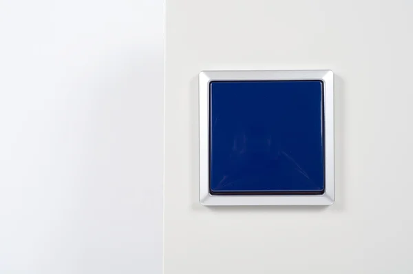 Włącznik światła na ścianie z niebieski przycisk rama srebrny — Zdjęcie stockowe