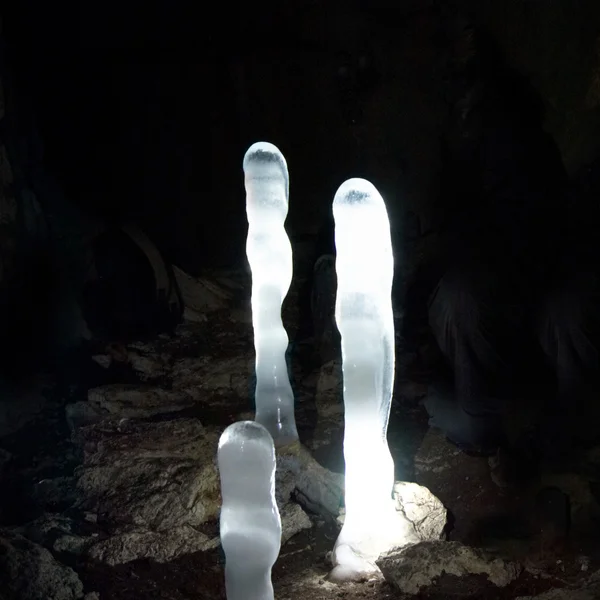 Luminescent ice stalagmites in the cave. — Stock Photo, Image