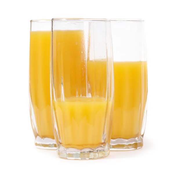 Três copos com suco de laranja — Fotografia de Stock