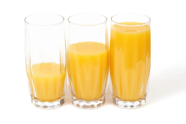 Tre bicchieri con succo d'arancia — Foto Stock