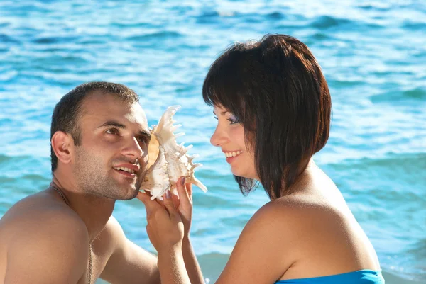 Young couple with seashell — Stock Photo, Image