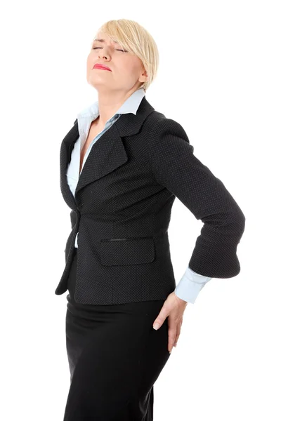 Reife Geschäftsfrau mit Rückenschmerzen. — Stockfoto