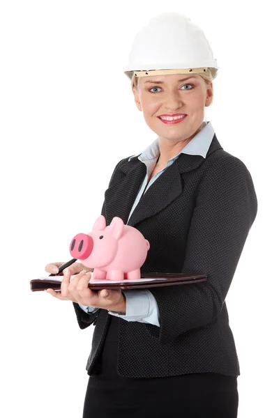 Mature engineer woman with piggybank. — Stock Photo, Image