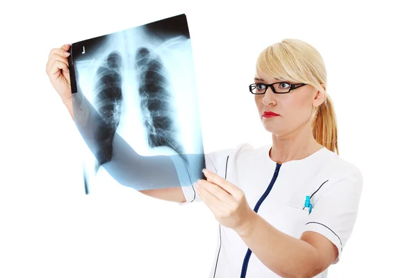 Жінка-лікар дивиться на рентгенівський знімок — стокове фото