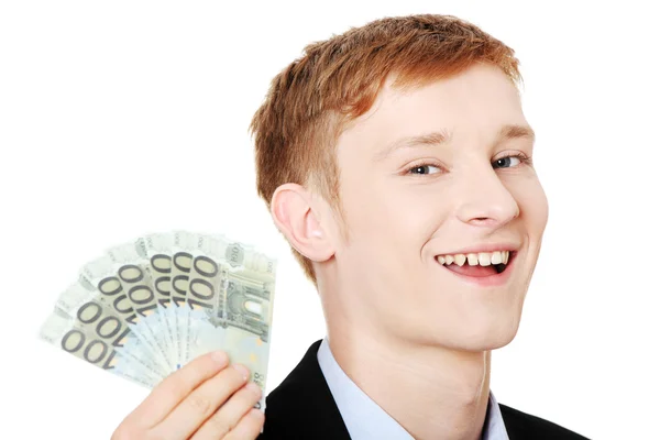 Joven hombre de negocios guapo sosteniendo euros —  Fotos de Stock