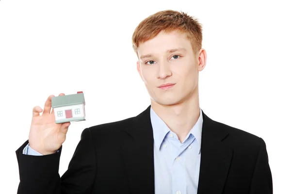 Young business man holding house model — Stock Photo, Image