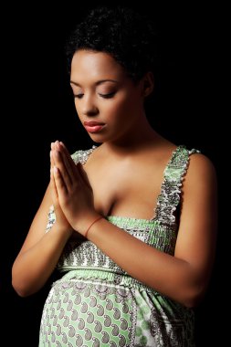 Young pregnant woman praying clipart