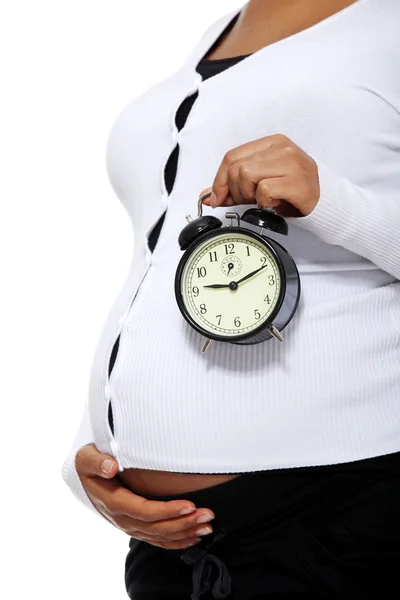 Gravid kvinna anläggning väckarklocka — Stockfoto