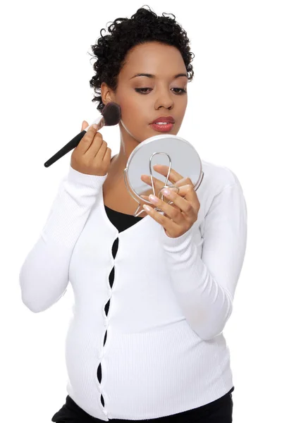 Pregnant woman doing a make up. — Stock Photo, Image