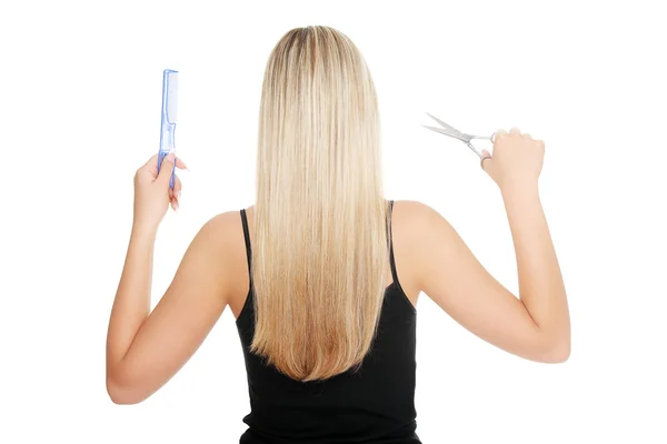 Young blond woman and hairdresser's tools — Stock Photo, Image