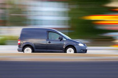 Speedy minivan is going on road clipart