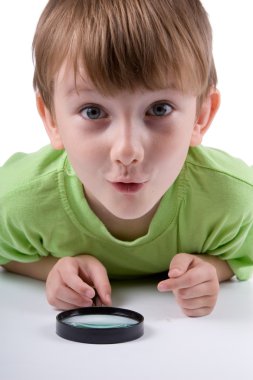 Boy with magnifying glass clipart