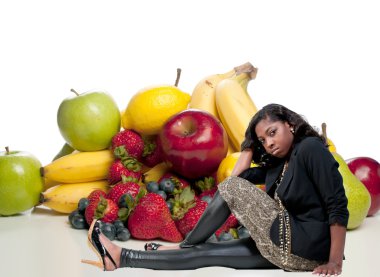 çeşitli meyveler ile oturan kadın