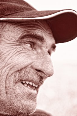 Closeup Profile on a Smiling Old Man With a Grey Beard clipart