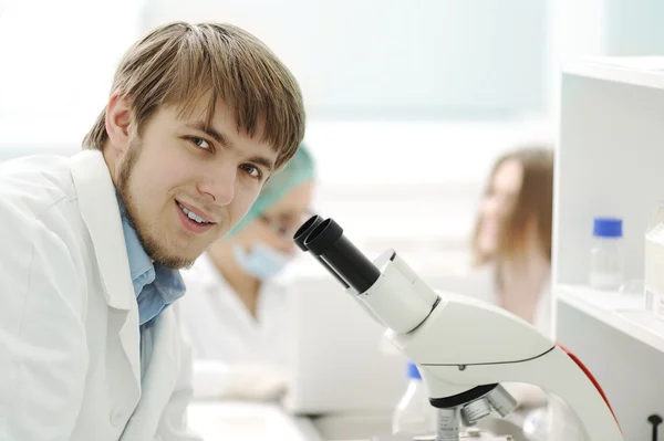 Equipe que trabalha com microscópios em laboratório — Fotografia de Stock