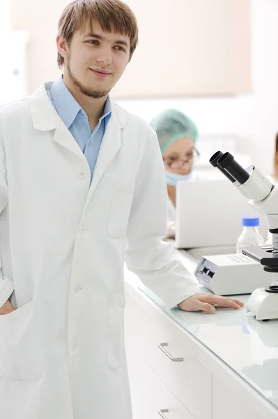 Successful team working with microscopes in a laboratory — Stock Photo, Image