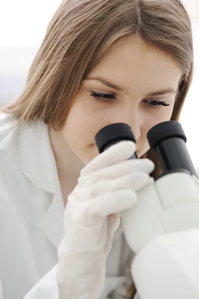 Γυναίκα ιατρός χρησιμοποιώντας μικροσκόπιο σε εργαστήριο — Φωτογραφία Αρχείου