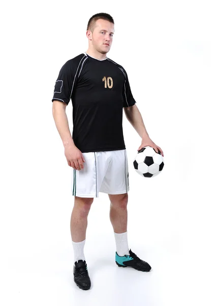 Piłkarz trzyma piłkę na białym tle — Zdjęcie stockowe