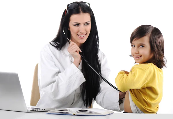 Young female doctor examining little cute child at modern hospital — Stock Photo, Image