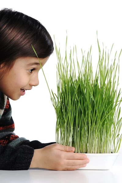 Веселый ребенок с травой в руках — стоковое фото