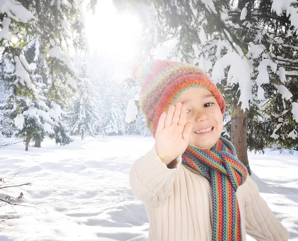 Portrait of happy kid wearing warm clothes in snow on a cold winter day, sm — Stock Photo, Image