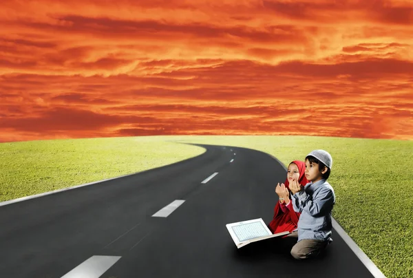 Two children sitting on road and reading — Stock Photo, Image