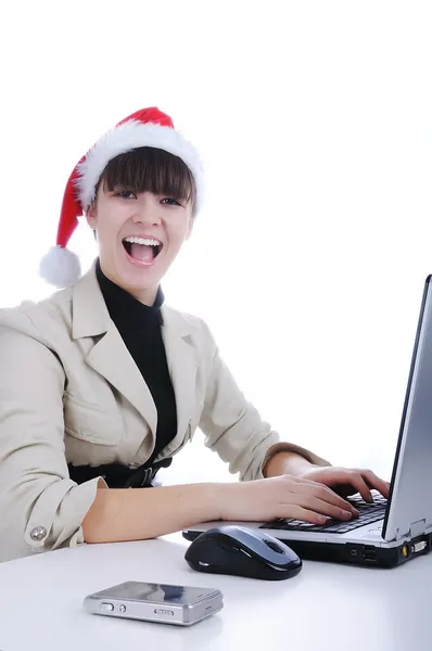 Beautiful business woman is working in office in santa claus hat — Stock Photo, Image