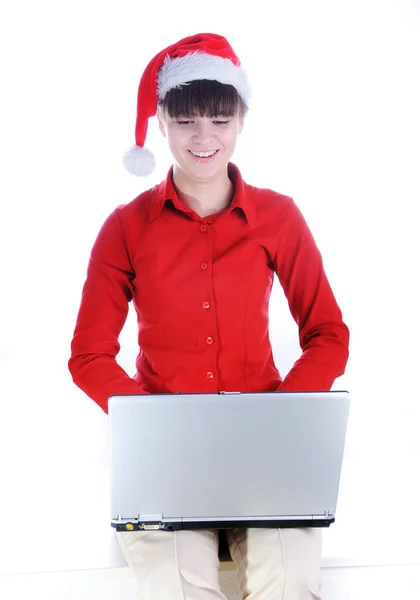 Santa girl with a laptop typing on — Stock Photo, Image