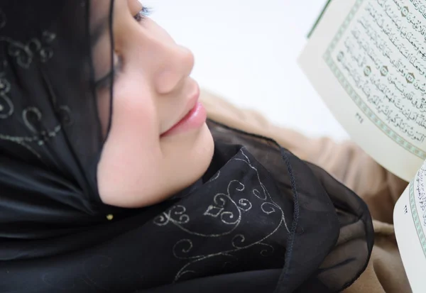Lilla flickan läsa heliga Koranen och leenden — Stockfoto