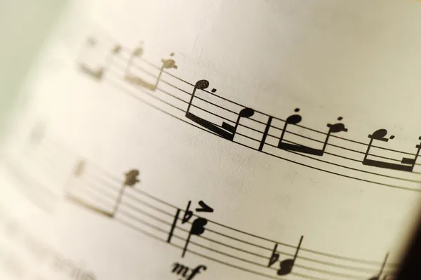 Closeup of old sheet music with selective focus and very shallow DOF — Stock Photo, Image