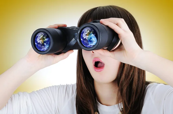 Girl with binoculars looking at the Earth — Stock Photo, Image