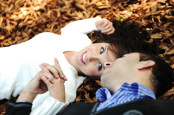 Close-up portrait of an beautiful autumn woman laying on ground — Stock Photo, Image