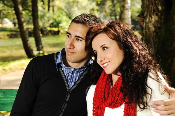 Young couple in nature sitting on bench, male and female together, love for — Stock Photo, Image