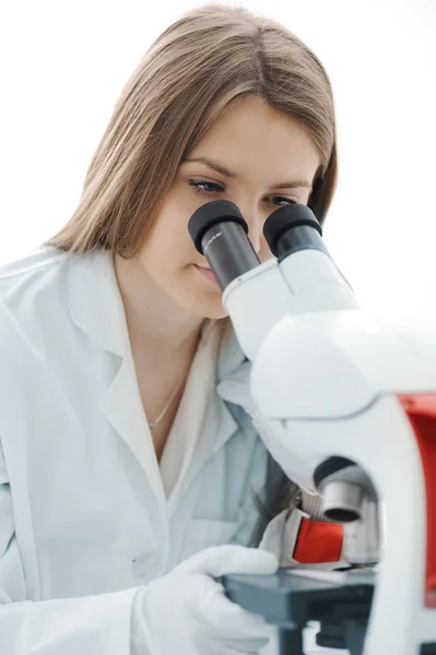 Beautiful female researcher using a microscope in a lab Stock Picture