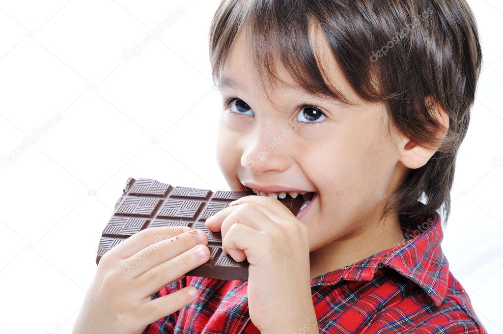 Cute kid isolated on white eating chocolate