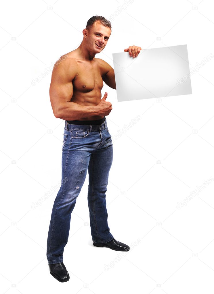 Young attractive male body builder with advertising copy space board. Studi