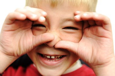 Happy blonde boy closeup, smiling, laughing, very happy with hands on his f clipart