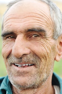 Face portrait of a wrinkled cheerful smiling senior man clipart